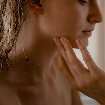 Close-up on a person's calm face during meditation.